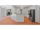 Kitchen with peninsula bar and stainless appliances overlooks the open living room at 619 Lovinggood Trl, Woodstock, GA 30189