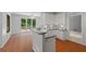 Bright eat-in kitchen featuring white cabinets, stainless steel appliances and breakfast bar at 619 Lovinggood Trl, Woodstock, GA 30189