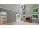 This living room features a stone fireplace, many windows, and open floorplan at 619 Lovinggood Trl, Woodstock, GA 30189