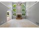Bright living room boasts many windows, fireplace, and high ceilings at 619 Lovinggood Trl, Woodstock, GA 30189