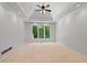 Spacious main bedroom with tray ceiling, fan, carpet and lots of natural light at 619 Lovinggood Trl, Woodstock, GA 30189