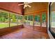 Inviting sunroom featuring wood floors and views of the well-maintained backyard at 619 Lovinggood Trl, Woodstock, GA 30189