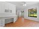 Sunroom with built-in desk, overlooking the backyard, that leads to the kitchen at 619 Lovinggood Trl, Woodstock, GA 30189