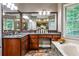 Elegant bathroom vanity features dark granite counters and wood cabinets, paired with tiled floors at 10575 Tuxford Dr, Alpharetta, GA 30022