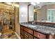 Bathroom featuring granite counters, cherry cabinets, with a glassed-in stone shower at 10575 Tuxford Dr, Alpharetta, GA 30022