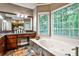 Bright bathroom with soaking tub, granite vanity, wood cabinets, and tiled floors at 10575 Tuxford Dr, Alpharetta, GA 30022