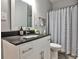 Well-lit bathroom features a sleek vanity with a dark countertop and modern fixtures at 10575 Tuxford Dr, Alpharetta, GA 30022