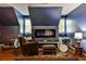 Bonus room featuring a sleek fireplace, hardwood floors, and eclectic decor at 10575 Tuxford Dr, Alpharetta, GA 30022