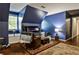 A versatile bonus room with modern fireplace, comfortable seating, and hardwood floors at 10575 Tuxford Dr, Alpharetta, GA 30022