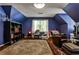 Cozy bonus room with hardwood floors, a sitting area, and natural light from a window at 10575 Tuxford Dr, Alpharetta, GA 30022