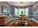 Charming dining room with hardwood floors, decorative molding, and large windows at 10575 Tuxford Dr, Alpharetta, GA 30022