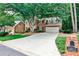 Charming two-story red brick home with a wide driveway and mature landscaping, offering great curb appeal at 10575 Tuxford Dr, Alpharetta, GA 30022