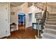 Inviting foyer with hardwood floors, staircase, and views into other rooms at 10575 Tuxford Dr, Alpharetta, GA 30022