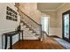 Inviting foyer with hardwood floors, staircase, and decorative accents leading into the home's interior at 10575 Tuxford Dr, Alpharetta, GA 30022