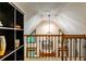 Bright hallway features an ornate metal railing and views of a windowed living space at 10575 Tuxford Dr, Alpharetta, GA 30022