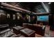 Home theater with a projector screen and leather seating at 10575 Tuxford Dr, Alpharetta, GA 30022