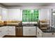 Beautiful kitchen features white cabinets, granite countertops, and stainless steel appliances at 10575 Tuxford Dr, Alpharetta, GA 30022