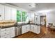Bright kitchen features white cabinets, granite countertops, and stainless steel appliances at 10575 Tuxford Dr, Alpharetta, GA 30022