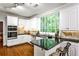Modern kitchen with granite counters, stainless appliances, and view to the backyard at 10575 Tuxford Dr, Alpharetta, GA 30022