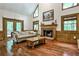 Inviting living room featuring a fireplace, hardwood floors, and scenic outdoor views at 10575 Tuxford Dr, Alpharetta, GA 30022