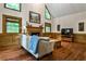 Comfortable living room with a fireplace, hardwood floors, and large windows with natural light at 10575 Tuxford Dr, Alpharetta, GA 30022