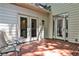 Outdoor patio with double doors, single door, light and two chairs at 10575 Tuxford Dr, Alpharetta, GA 30022