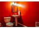 Bright powder room with pedestal sink, mirror, and tile flooring at 10575 Tuxford Dr, Alpharetta, GA 30022