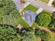 Aerial perspective of a home highlighting the backyard patio, landscaping, and roof at 1125 Fairview Club Cir, Dacula, GA 30019