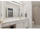 Well-lit bathroom featuring a large mirror, white vanity, and a shower with a curtain at 1125 Fairview Club Cir, Dacula, GA 30019