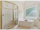 Bathroom with white cabinets, tub, and separate glass shower stall at 1125 Fairview Club Cir, Dacula, GA 30019