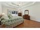 Large main bedroom with trey ceiling, hardwood floors, and natural light at 1125 Fairview Club Cir, Dacula, GA 30019