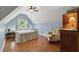 Attic bedroom with hardwood floors, a cozy chair, and a dormer window providing natural light at 1125 Fairview Club Cir, Dacula, GA 30019