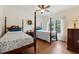 Traditional bedroom featuring two four-poster beds, hardwood floors, and natural light at 1125 Fairview Club Cir, Dacula, GA 30019