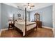 Charming bedroom with a four-poster bed, hardwood floors, and soft blue walls at 1125 Fairview Club Cir, Dacula, GA 30019