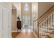 Bright foyer with hardwood floors, staircase, and a view of the front door at 1125 Fairview Club Cir, Dacula, GA 30019