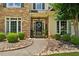 Inviting front entrance with stone accents, decorative wreath, and manicured landscaping at 1125 Fairview Club Cir, Dacula, GA 30019