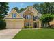 Beautiful two-story home featuring a stone facade, well-manicured lawn, and a two-car garage at 1125 Fairview Club Cir, Dacula, GA 30019