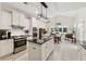 Spacious kitchen with white cabinets, black countertops, island, and adjacent breakfast nook at 1125 Fairview Club Cir, Dacula, GA 30019