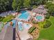 Aerial view of a swimming pool complete with water slides, pools, chairs and umbrellas at 1125 Fairview Club Cir, Dacula, GA 30019