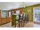 Open breakfast bar area with seating for four, a view to the backyard and adjacent living space at 1441 Saint George Pl, Conyers, GA 30012