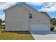 Two-story house exterior showcasing the attached garage and well-maintained lawn at 1441 Saint George Pl, Conyers, GA 30012