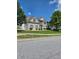 This home features a brick veneer, two-car garage, and manicured lawn at 1441 Saint George Pl, Conyers, GA 30012