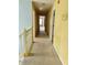 Hallway with yellow walls and carpet flooring. Connecting various rooms throughout the home at 1441 Saint George Pl, Conyers, GA 30012
