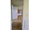 Hallway with laminate floors and a view of the living room and staircase at 1441 Saint George Pl, Conyers, GA 30012