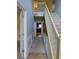 Hallway with decorative molding and a view of the kitchen at 1441 Saint George Pl, Conyers, GA 30012