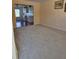 Living room featuring neutral carpeting with kitchen view at 1441 Saint George Pl, Conyers, GA 30012