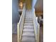 Carpeted stairway with white railing leads to the second floor of this lovely home at 1441 Saint George Pl, Conyers, GA 30012