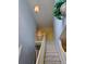Carpeted stairway with high ceilings and a decorative light fixture at 1441 Saint George Pl, Conyers, GA 30012