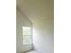 Well-lit room with high ceilings and a window overlooking the trees at 116 Ventura Trl, Stockbridge, GA 30281