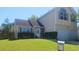 Charming two-story home with a well-maintained lawn and a two-car garage, perfect for a growing Gathering at 116 Ventura Trl, Stockbridge, GA 30281